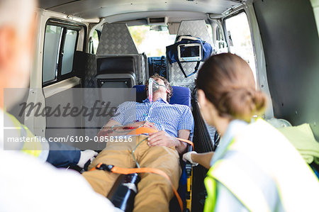 Injured man with ambulance men