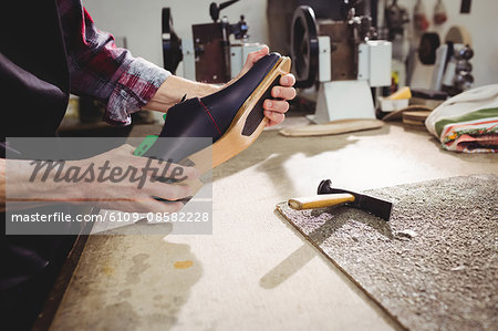 Close up of hands holding a shoe