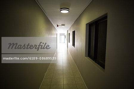 Ceiling lights glowing in empty hospital corridor