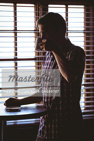 Man drinking alone a coffee in a cafe