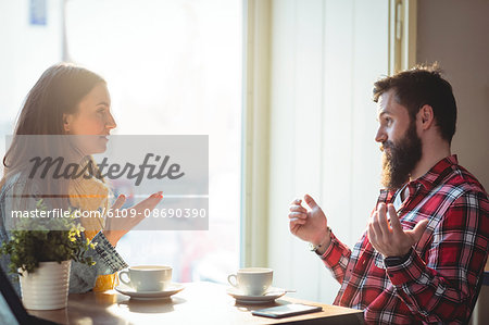 Young Man and woman talking at cafe