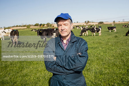 Portrait of confident worker standing on grassy field