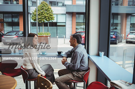 Man and woman having conversation in the cafeteria