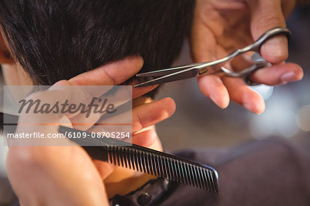 Female getting her hair trimmed at a salon