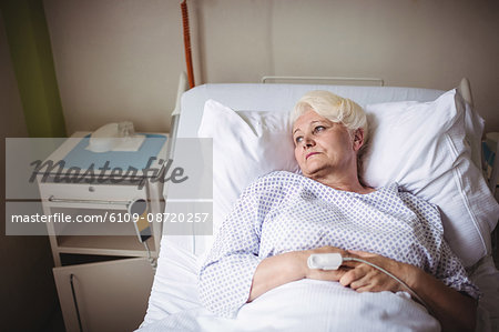 Thoughtful senior woman on a bed in hospital Thoughtful senior woman on a bed in hospital