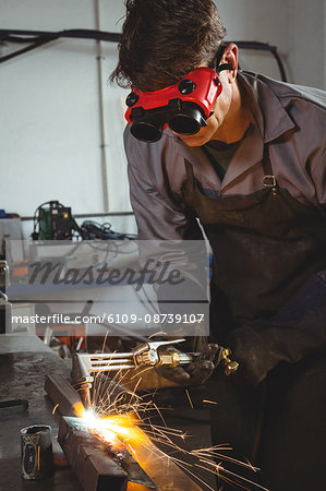 Welder welding a metal in workshop