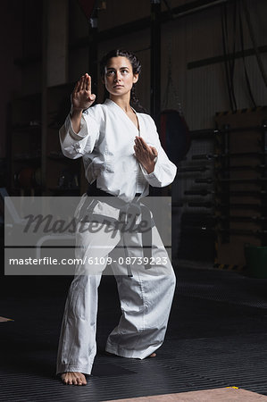 Woman practicing karate in fitness studio