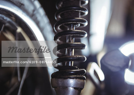 Close-up of motorbike shock absorber in workshop