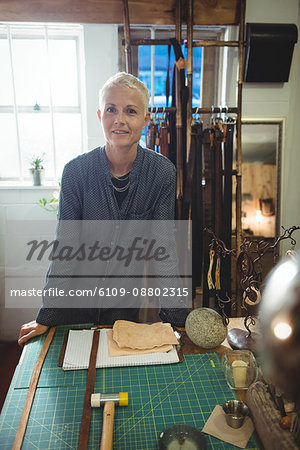 Portrait of confidence craftswoman standing in workshop