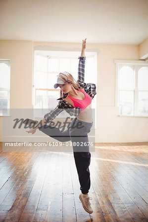 Young woman practising hip hop dance in studio