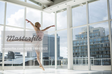 Ballerina practicing a ballet dance in ballet studio