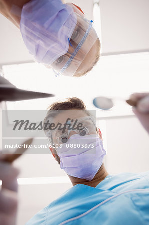 Close-up of dentists holding dental tools at dental clinic