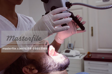 Female dentist examining patient in dental clinic