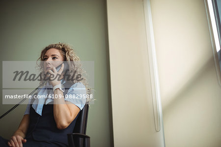 Businesswoman talking on landline