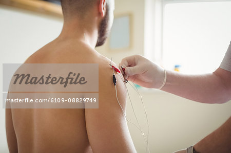 Close-up of Physiotherapist inserting needles on patient