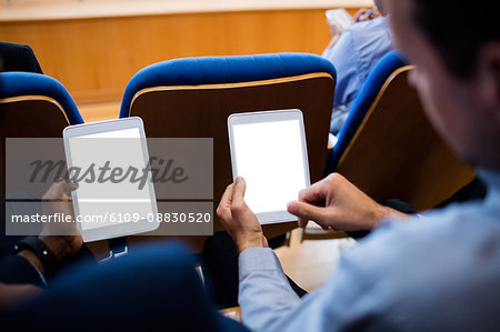 Business executives participating in a business meeting using digital tablet