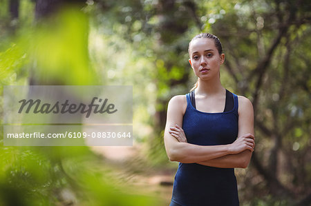 Portrait of beautiful woman standing with arms crossed
