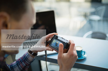 Business executive taking a picture of coffee cup in cafeteria