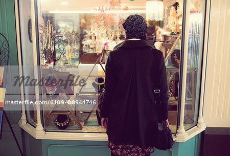 Rear-view of woman looking at jewelry counter in the supermarket