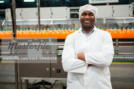Portrait of confident male worker standing in juice factory