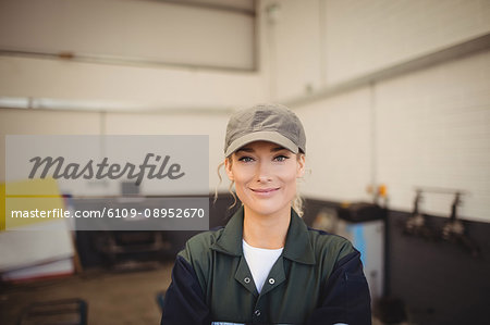 Portrait of female mechanic in repair garage