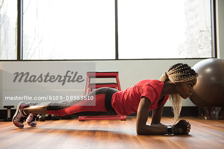 Fit woman performing fitness exercise in the gym