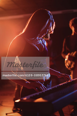 Musician playing electronic piano in recording studio