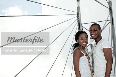 Young African couple standing together on a bridge, Newtown, Johannesburg