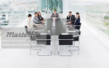 Portrait of smiling business people at conference room table