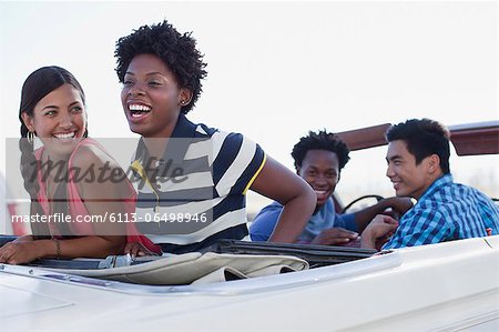 Friends sitting in convertible together