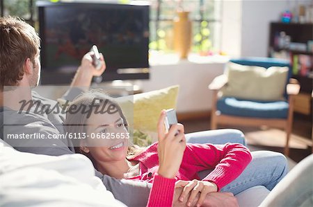 Couple relaxing on sofa together