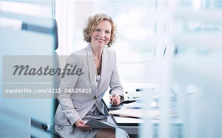 Businesswoman smiling at desk