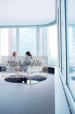 Businesswomen talking in office lobby