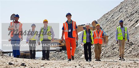 Workers and business people walking in quarry