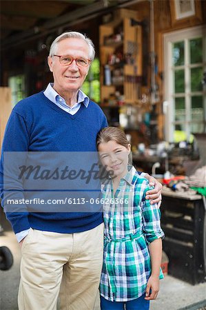 Man and granddaughter smiling in garage