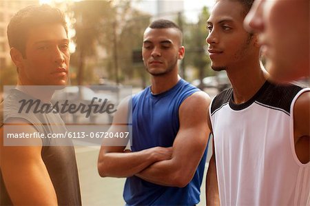 Men standing on basketball court