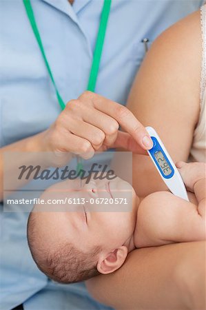 Nurse taking baby's temperature