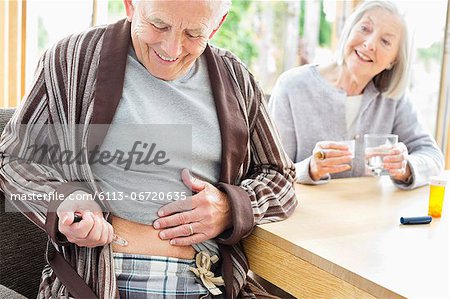 Older man giving himself injection