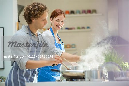 Couple cooking in kitchen