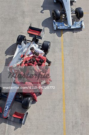 Race team surrounding racer on track