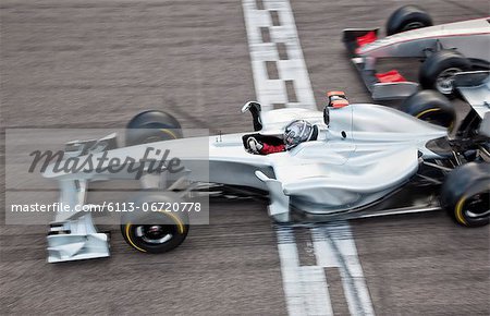 Race car crossing finish line on track