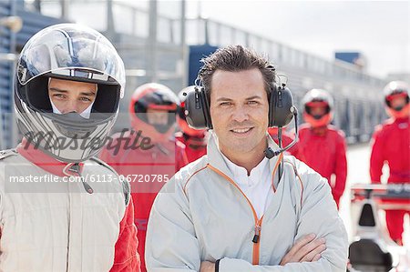 Racer and manager standing on track
