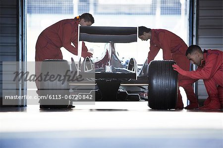 Racing team working in garage