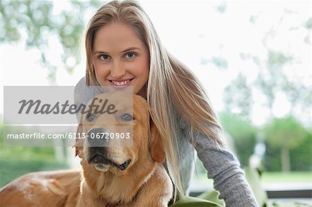 Woman relaxing with dog indoors