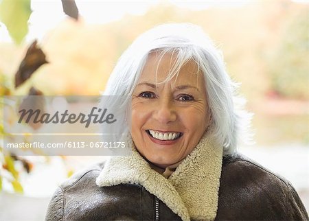 Smiling older woman standing outdoors