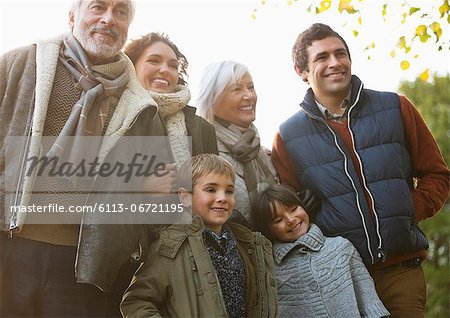 Family smiling together in park