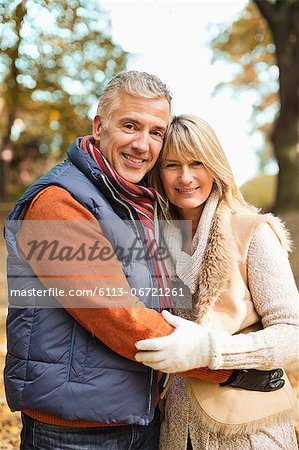 Older couple hugging in park