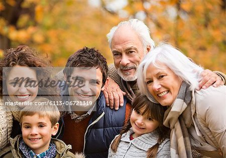 Family smiling together in park