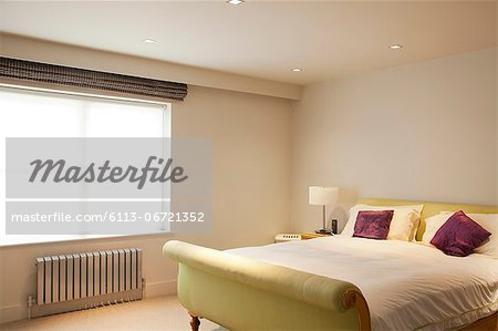 Bed and radiator in modern bedroom