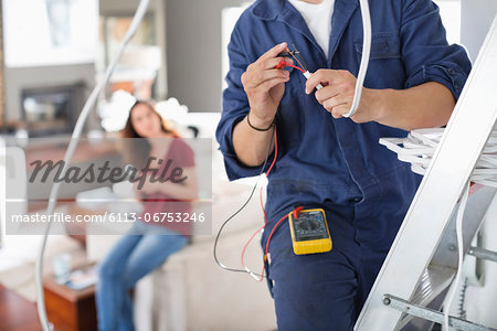 Electrician working in living room